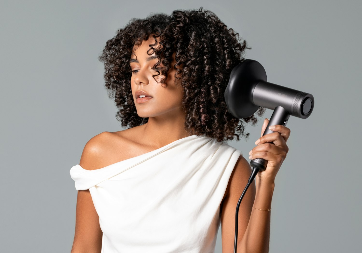 Curly hair being blow-dried